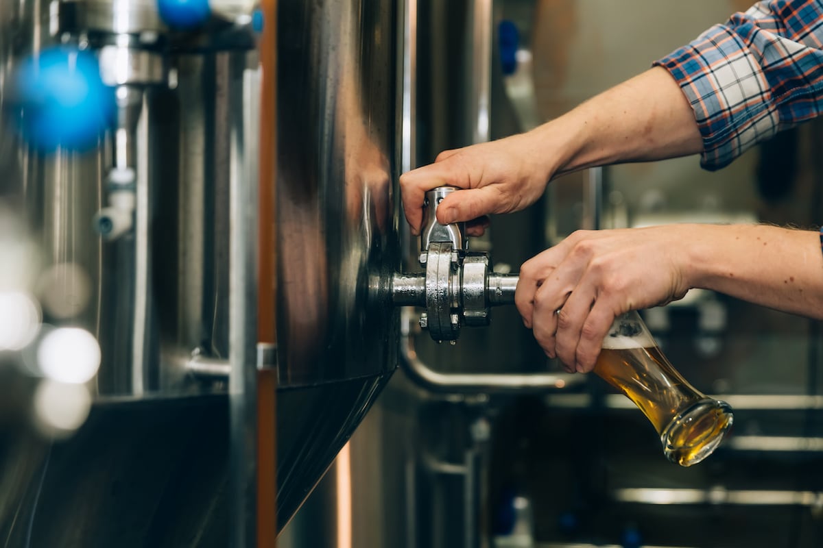 pouring beer from tank at brewing facility - preventing excessive foam